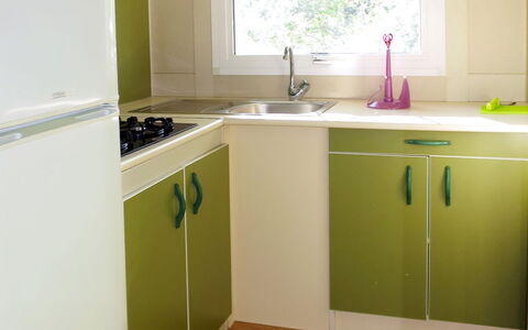 Camping Village Il Fontino: Room, Kitchen, Property, Floor, Cabinetry, Countertop, Furniture, Green, Hardwood, Wood Flooring
