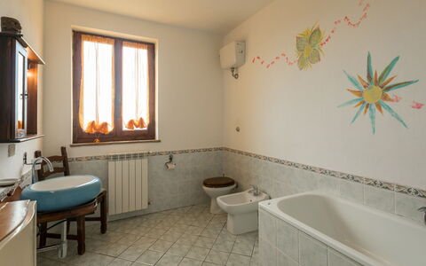 Valmarinella: Mirror, Bathtub, Property, Window, Plumbing Fixture, Sink, Tap, Interior Design, Bathroom, Lighting