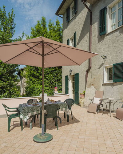 Stella: Furniture, Property, Table, Building, Sky, Window, Chair, Shade, Outdoor Table, Outdoor Furniture