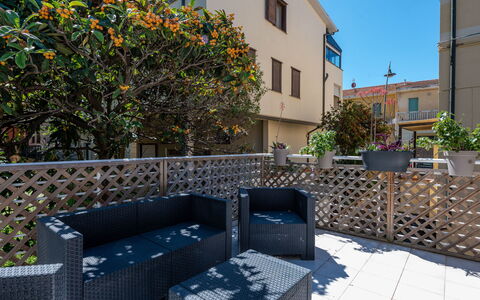 Elena: Property, Plant, Window, Building, Couch, Sky, Road Surface, Outdoor Furniture, Flowerpot, Urban Design