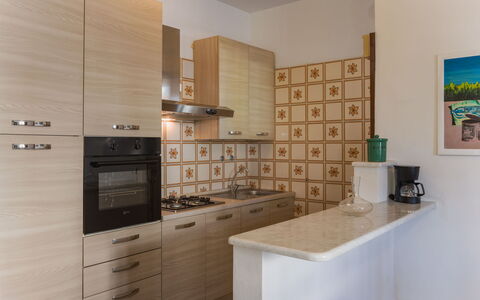 Grande Appartamento: Kitchen, Countertop, Kitchen Appliance, Cabinetry, Major Appliance, Flooring, Interior Design, Wood, Floor, Furniture