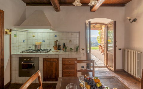 Vista del Lago 12: Wall, Flooring, Furniture, Interior Design, Home, Door, Chair, Wood Stain, Hardwood, Kitchen