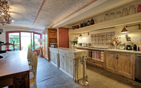 Villa Nova: Furniture, Property, Cabinetry, Table, Building, Countertop, Kitchen, Interior Design, Wood, Lighting